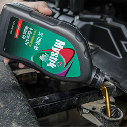Mystik lubes being poured into car