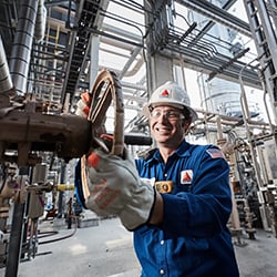 Worker turning valve in refinery