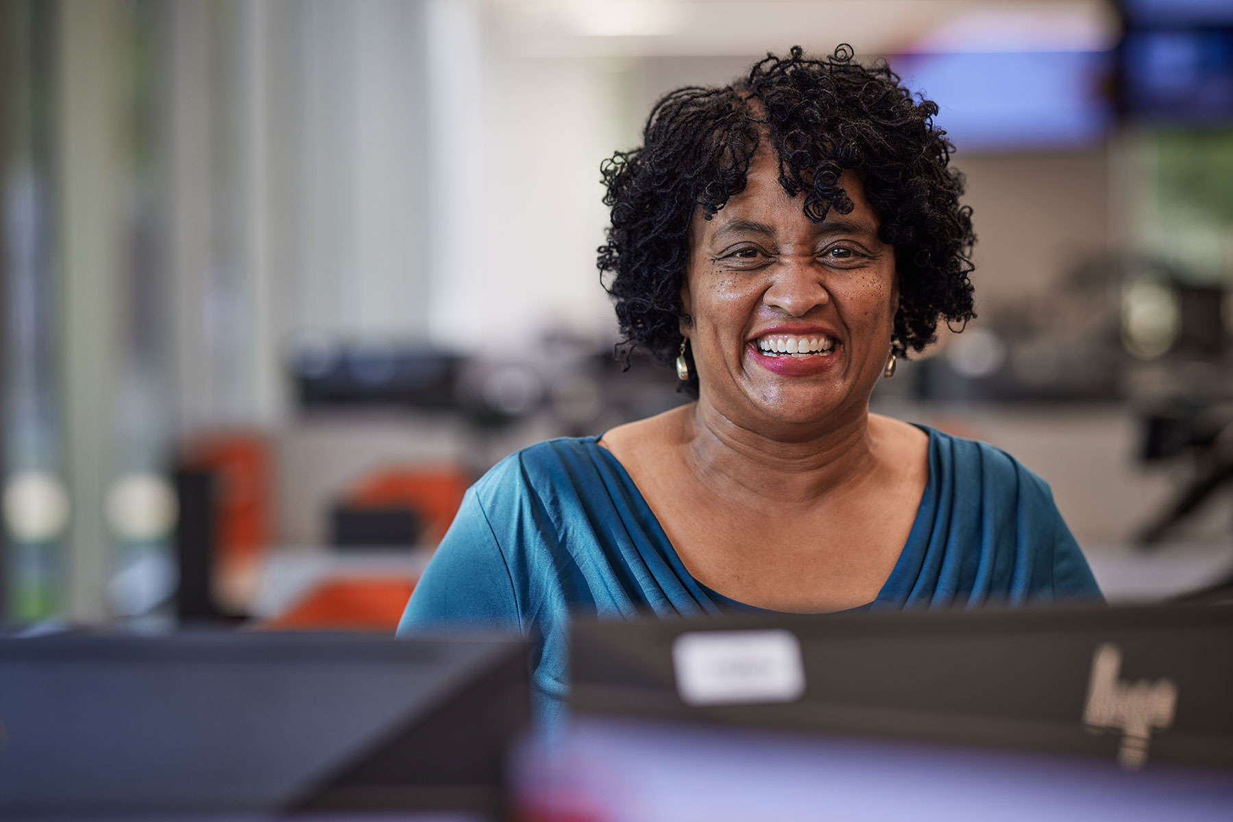 CITGO employee smiling behind desk.