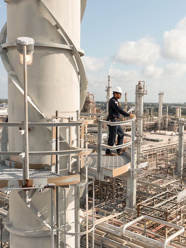 Worker on top of refinery