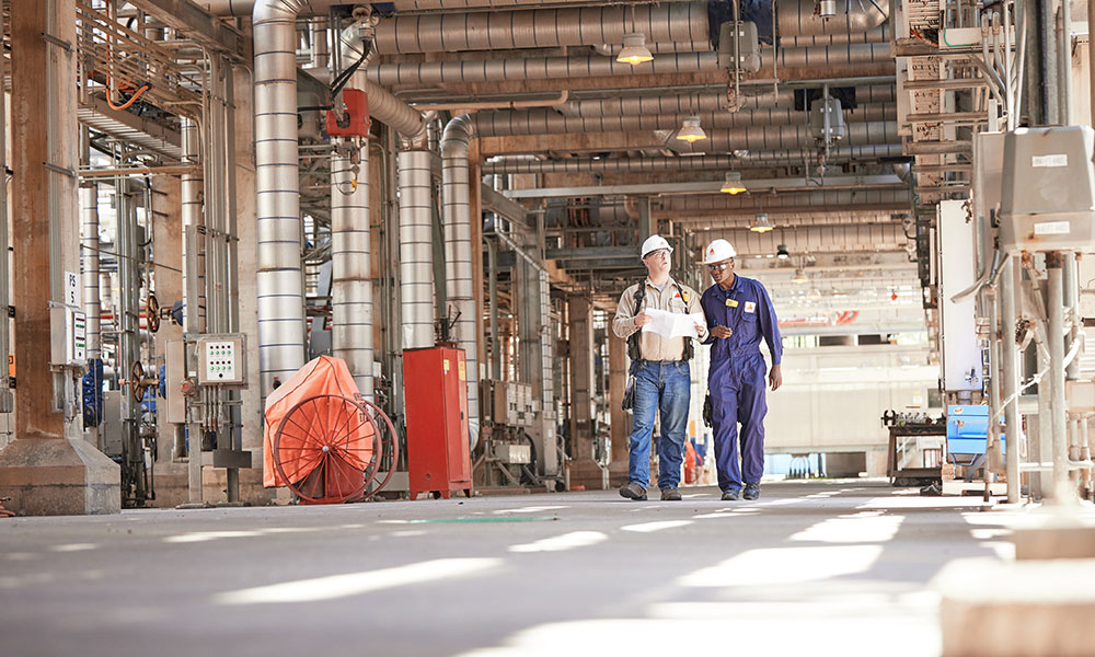 Men walking through refinery