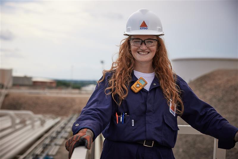 Lady standing in the field at the Lemont Refinery